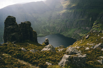 High angle view of lake by rocky mountains