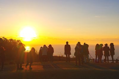 Silhouette of people at sunset