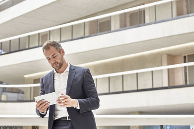 Businessman using tablet in office building