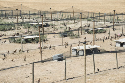 High angle view of fence on sand