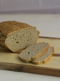 View of loaf of brown bread with two slices