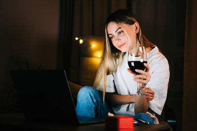 Young woman using mobile phone at home