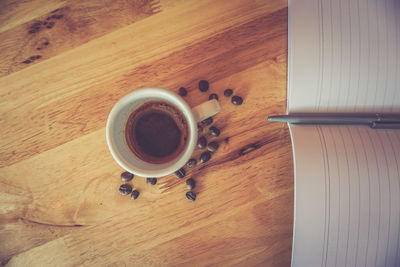 High angle view of coffee cup on wooden table