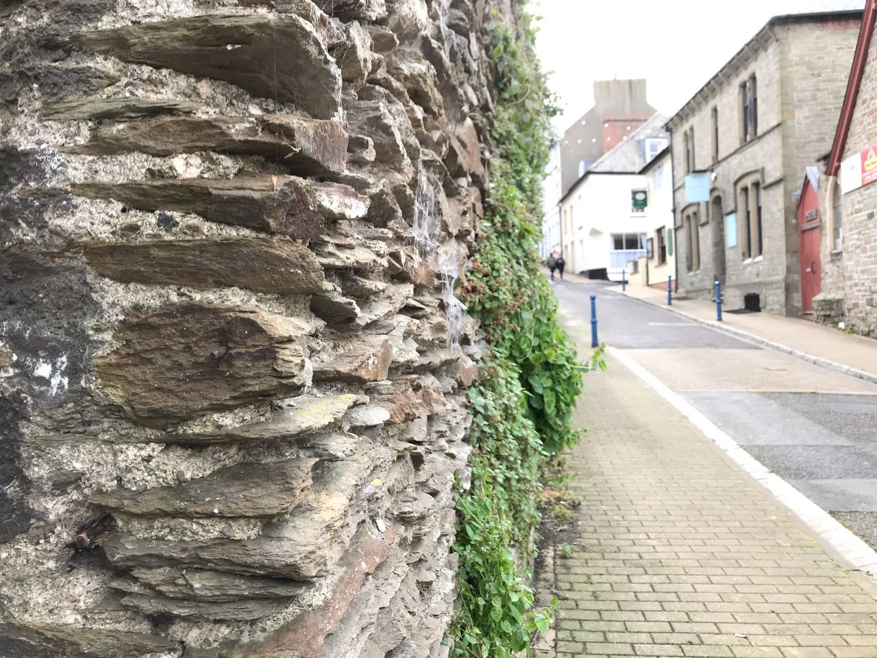 architecture, built structure, building exterior, wall - building feature, building, wall, day, city, no people, outdoors, street, nature, plant, brick, brick wall, footpath, stone wall, close-up, direction, focus on foreground, alley