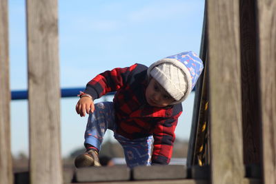 Boy playing on jungle gym at park