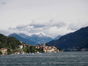 Scenic view of sea by buildings against sky