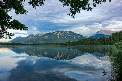 Scenic view of lake and mountains against sky