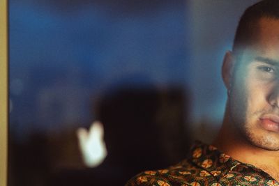Close-up portrait of young man at home
