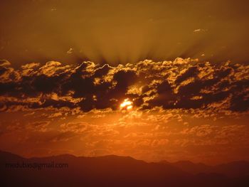 Scenic view of silhouette mountains against sky during sunset