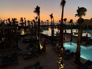 View of swimming pool at beach during sunset