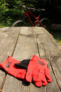 High angle view of red bicycle on wooden bench