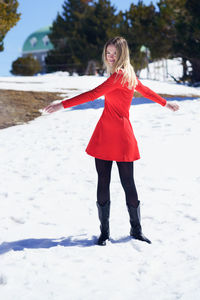Full length of woman standing on snow covered land