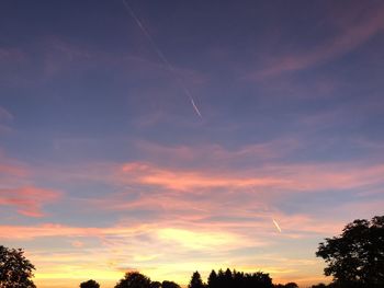 Low angle view of silhouette trees against sky at sunset