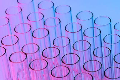 Close-up of test tubes against colored background