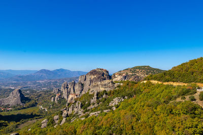 Scenic view of rocky mountains against clear blue sky