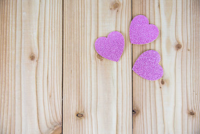 Close-up of heart shape on pink wood