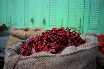 Close-up of dried red chili peppers for sale in sack