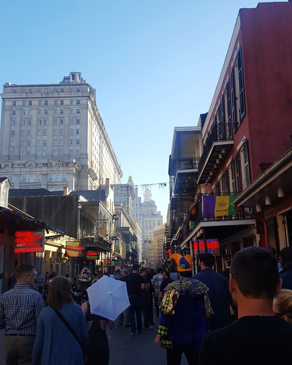 architecture, building exterior, built structure, real people, large group of people, city, men, women, lifestyles, day, city life, street, leisure activity, outdoors, clear sky, sky, crowd, people