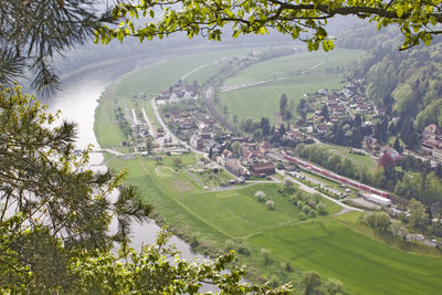 High angle view of trees and buildings on field