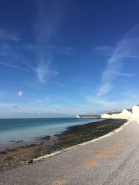 Scenic view of beach against blue sky