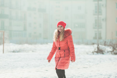 Portrait of woman with red umbrella during winter