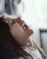 Close-up of girl laughing at home