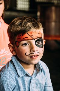 Close-up of boy with face paint looking away