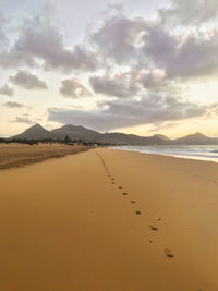 Scenic view of beach against sky during sunset