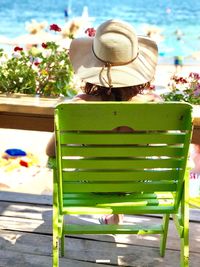 Close-up of green hat with flowers in background