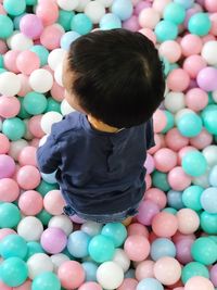 High angle view of baby boy playing with balls