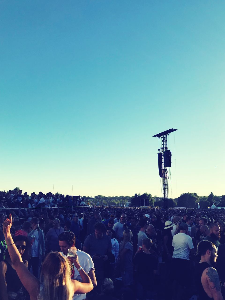 PEOPLE AT MUSIC CONCERT AGAINST BLUE SKY