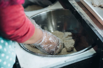 Cropped hand of person preparing food