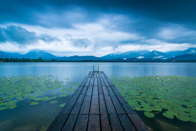 Pier over lake against sky