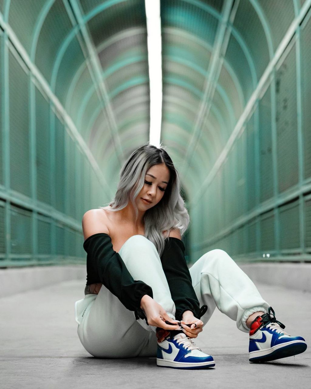 FULL LENGTH OF WOMAN SITTING IN A BUILDING