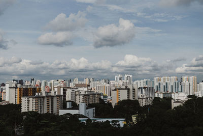 Cityscape against cloudy sky