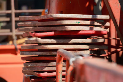 Close-up of old traffic cones stacked during sunny day