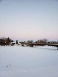 Snow on field against clear sky during winter