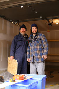 Portrait of carpenters standing at workshop