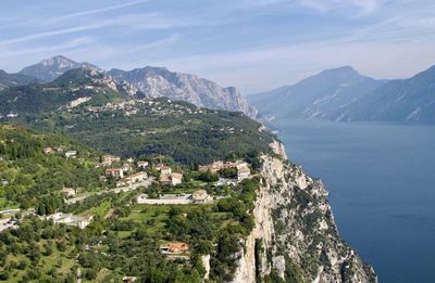 Scenic view of townscape by lake garda against sky