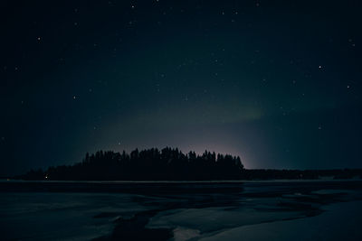 Scenic view of lake against sky at night