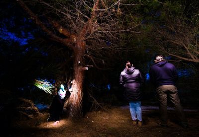 Full length of woman standing in forest