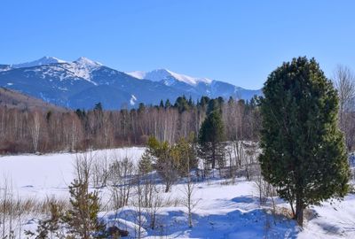 Scenic view of snow covered mountains against clear sky