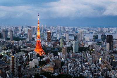 Aerial view of buildings in city against sky