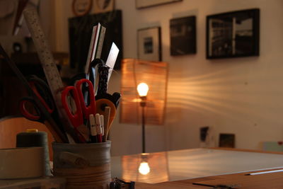 Close-up of illuminated candles on table at home