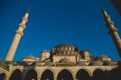 Low angle view of historic building against clear blue sky