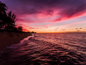 Scenic view of sea against romantic sky at sunset