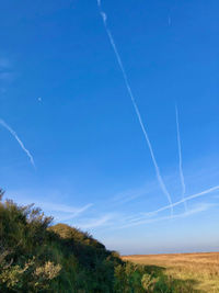 Low angle view of vapor trails in sky