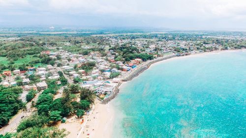 High angle view of sea and cityscape against sky