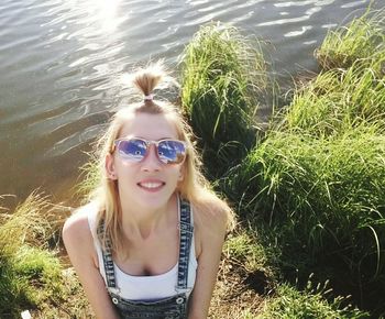 Portrait of happy young woman in grass