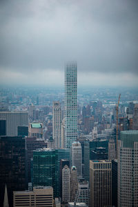 Aerial view of modern buildings in city against sky